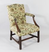 A George III mahogany Gainsborough chair, with moulded arms and blind fret carved front legs, with