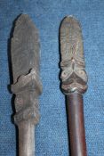 A Maori Taiaha long club fighting staff, with stone carved upoko and arero, together with another