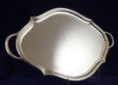 A 1930`s plain silver two handled tea tray, of shaped lozenge form, with reeded border, Barker