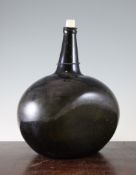 A large dark olive green glass wine bottle, 18th century, of flattened flask form, short tapered