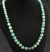 A 1920`s single strand graduated emerald bead necklace, with gold, silver, diamond and cultured