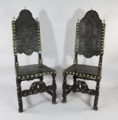A pair of late 17th century Portuguese carved walnut and leather embossed side chairs, with brass