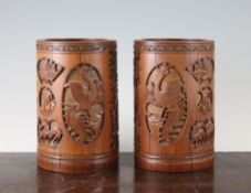 A pair of Chinese bamboo brush pots, late 19th century, each decorated with a main reserve of