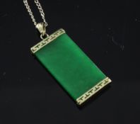 A 14ct gold mounted jadeite pendant, of rectangular form, (lacking mount), on a fine link chain,