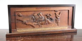 A Chinese Ginkgo wood shutter panel, 19th century, one side carved in high relief with the reclining