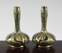 A pair of Moorcroft Macintyre `Gold and Green Florian` small bottle vases, c.1910, inscribed `W.M`