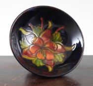 A Moorcroft `Columbine` flambe small footed bowl, c.1955, on dark blue ground, impressed `Moorcroft`