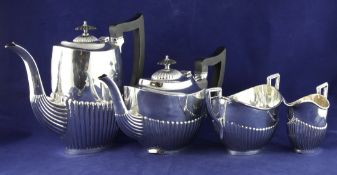A George V demi fluted silver oval four piece tea and coffee set, W & E.V, Sheffield, 1912/15, gross