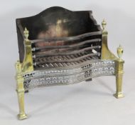 A George III serpentine steel and brass fire grate, with floral engraved decoration, brass shaped