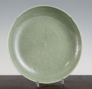 A Chinese celadon glazed dish, Guangxu mark but later, incised with twin fish within scrollwork