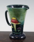 A Moorcroft `Claremont` jug, c.1928-49, with mottled green blue ground, inscribed `W Moorcroft`