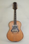 A Neapolitan mandolin, guitar shaped, the back decorated with a lady playing a rebec, with