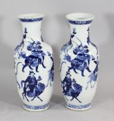 A pair of large Chinese blue and white baluster vases, 19th century, each finely painted with