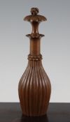 A Continental carved treen bottle, with fluted body, the stopper with carved knop finial, 9.5in.