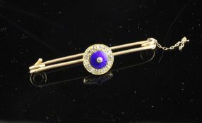 A gold, blue enamel and diamond set button, now mounted on a 15ct gold pin, 2in. Starting Price: £