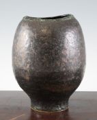 Chris Carter (1945-). A stoneware rounded vase, with shaped oval rim, covered in a shiny green and