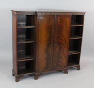 An Edwardian mahogany breakfront bookcase, with two central doors and open shelves, on shaped