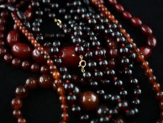 A single strand graduated red amber bead necklace, and five other assorted necklaces. Starting