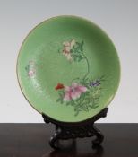A Chinese green ground famille rose saucer dish, Qianlong mark, late 19th / early 20th century,