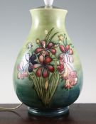 A Walter Moorcroft `Spring Flowers` lamp, on mottled green ground, inscribed `W.M` mark, impressed