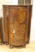 A Hepplewhite revival serpentine side cabinet, with two cupboard doors revealing pigeon holes and