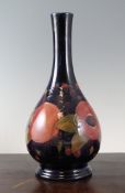 A Moorcroft `Pomegranate` pear shaped bottle vase, c.1920, with cobalt blue ground, inscribed