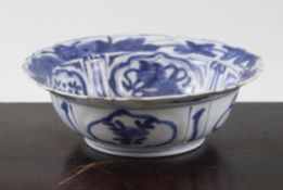 A Chinese blue and white Kraak style bowl, with barbed rim, the interior painted with a bird amid