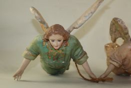 A French painted wood hanging angel figure with open arms and glass eyes, together with another