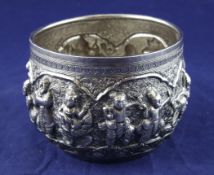 A 19th century Burmese silver bowl, embossed with continuous scene of figures at various pursuits,