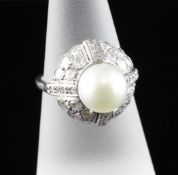 A white gold, cultured pearl and diamond set target ring, of domed form, size M. Starting Price: £