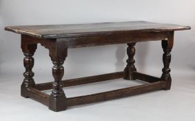An oak refectory style dining table, with carved frieze, turned legs and stretcher base, L.6ft