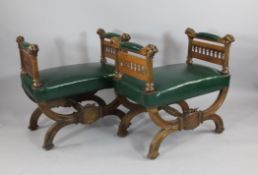 A pair of 19th century gothic oak `X` frame window seats, with ball and claw carved arms, gothic