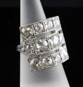 A 1950`s platinum and twelve stone diamond cluster ring, of concave square design, approximate total