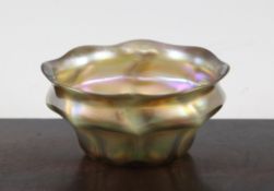 A Tiffany favrile iridescent glass small bowl, c.1910, of squat panelled form with wave rim,