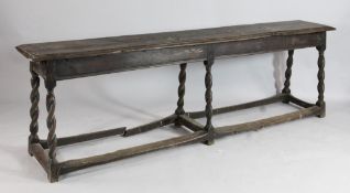 An 18th century oak bench seat, with barley twist supports united by stretchers, W.5ft 10in.