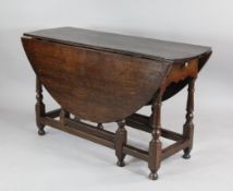 An 18th century oak gateleg table, with single end drawer, turned legs and `H` stretchers, W.4ft