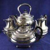 Four Edwardian matched silver items of tea and coffee ware, of oval form, with gadrooned borders, on