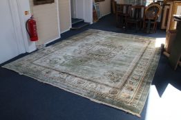 A Chinese carpet, with central rectangular floral scroll medallion, on a pale green ground, with