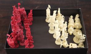 A Chinese carved ivory chess set, with red stained and natural opposing pieces, carved as various