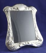 A 1980`s Art Nouveau style Brittania standard silver photograph frame, decorated with stylised