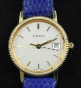 A lady`s 18ct gold Tissot quartz wrist watch, with baton numerals, date aperture and case back