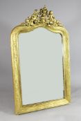 A late 19th century gilt gesso wall mirror, with leaf and berry decorated frame and later flower and