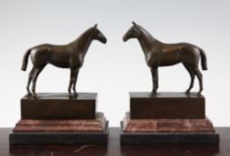 A pair of bronze equestrian bookends, on stepped square bases, signed Andre, 8.5in. Starting