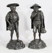 A pair of large Japanese bronze figures of a fisherman and woman, late 19th century, both wearing