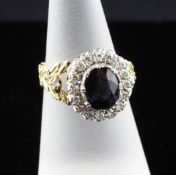 A Victorian style 18ct gold, sapphire and diamond set dress ring, the oval cut sapphire bordered