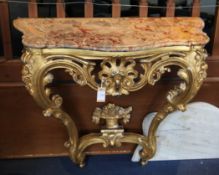 An early 19th century carved giltwood and gesso marble top console table, on double scroll legs