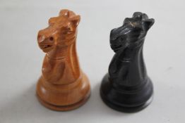 A Victorian Jaques & Son staunton chess set, the whites carved in boxwood, the black side in