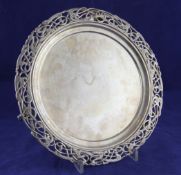 An Edwardian Irish silver salver, of circular form, with pierced stylised scrolling border, on