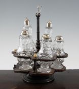 A 19th century lignum vitae cruet stand, with five cut glass bottles, with unmarked silver tops,