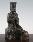 A Chinese bronze seated figure of an official, inscribed to the back, 10.8in. and a Chinese bronze